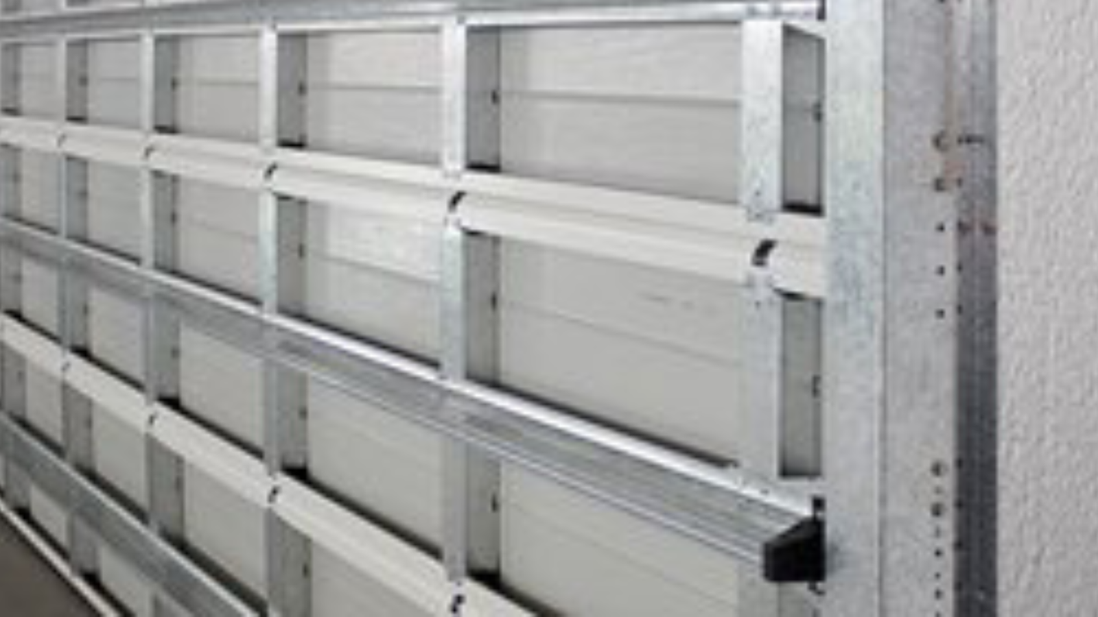 Industrial storm shield sectional door protecting a commercial facility